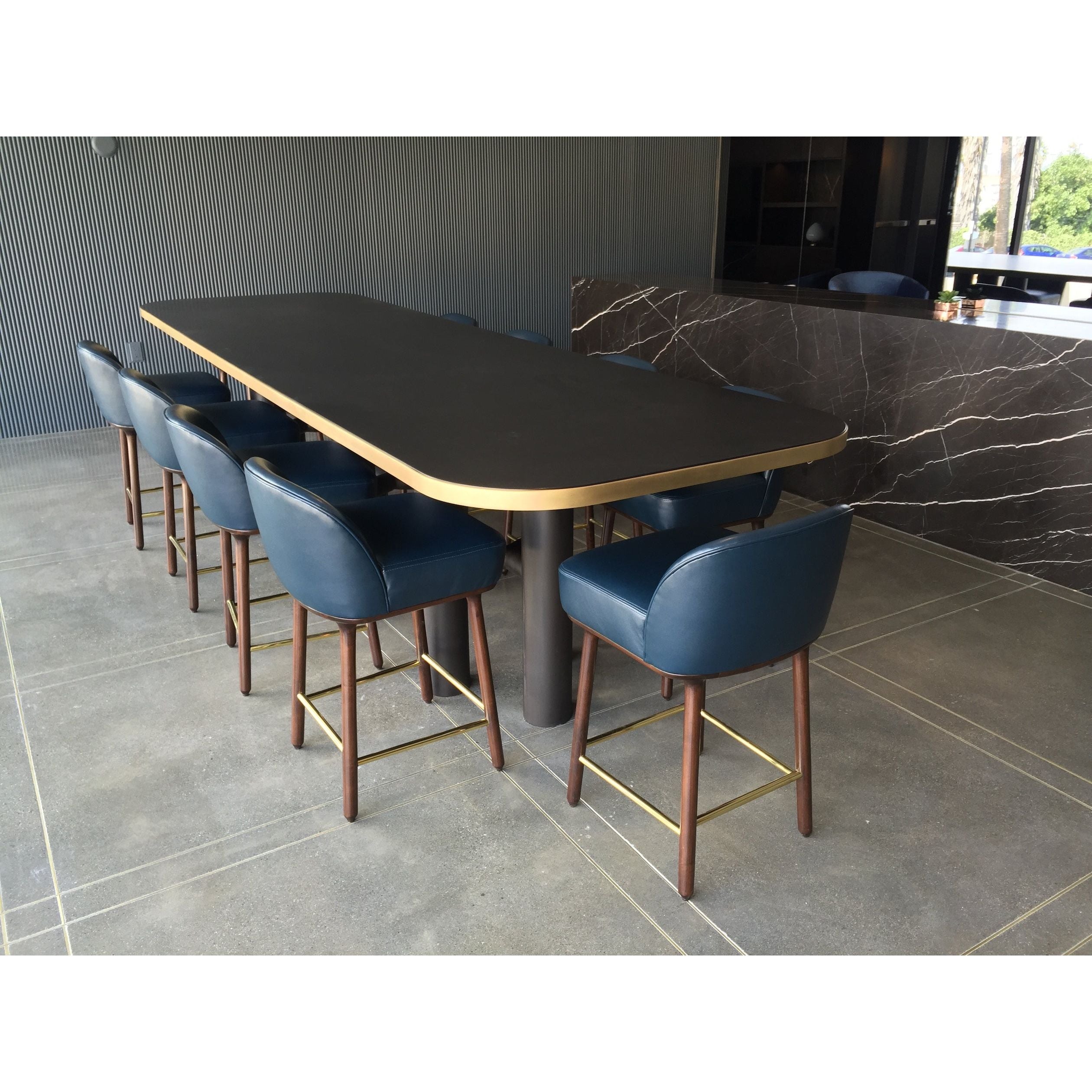 modern conference table with walnut top and brass trim with industrial metal base