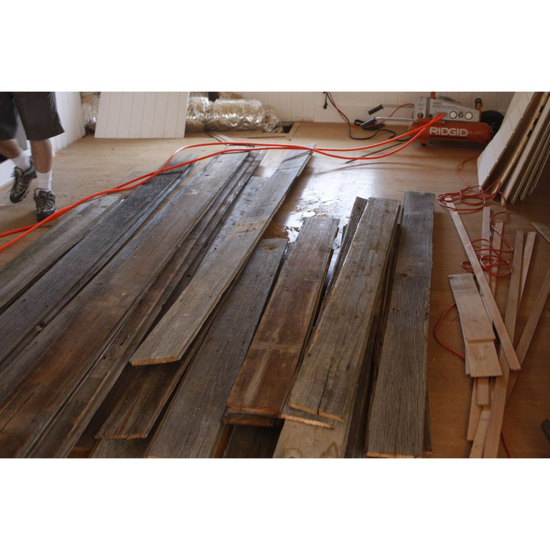 sorting the reclaimed barn wood for installation 